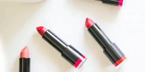 four different organic lipsticks on a table