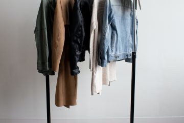 capsule wardrobe with few items of clothing hanging on the clothing rack