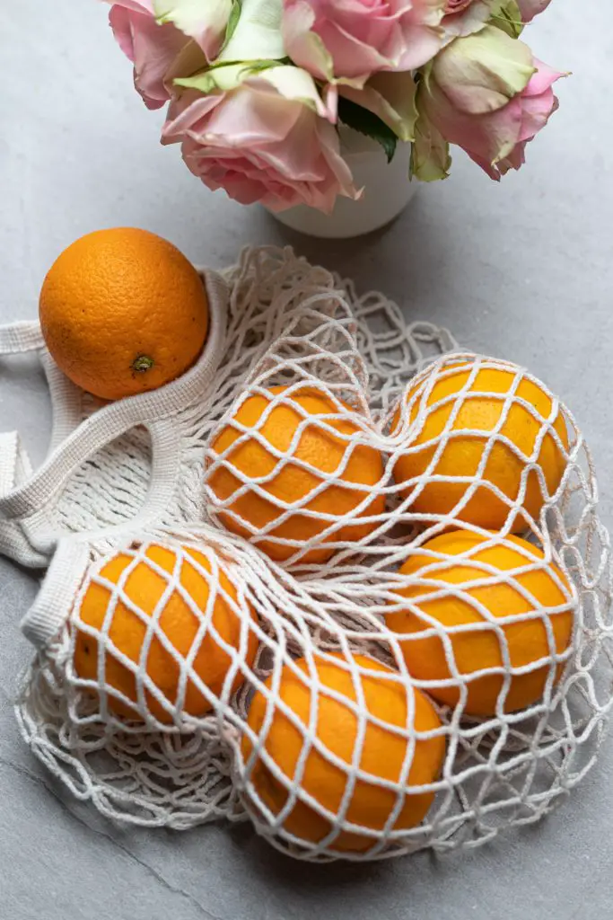 eco friendly mesh bag with oranges in it 