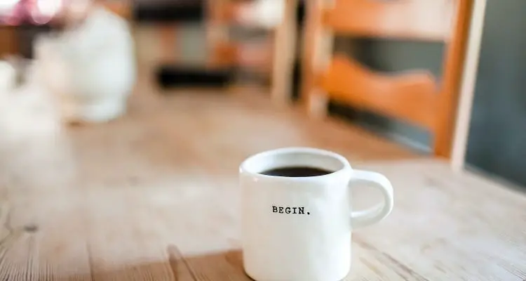 a coffee cup with the word begin on it