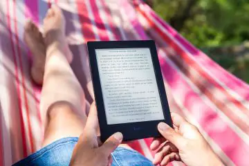 woman reading a book on the kindle