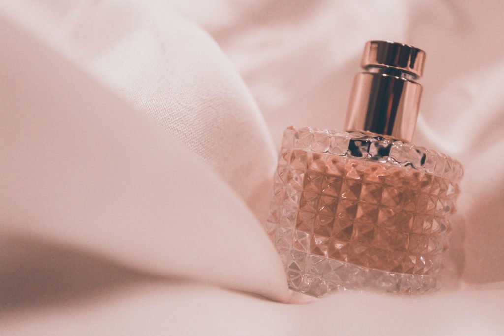 perfume bottle on a bed